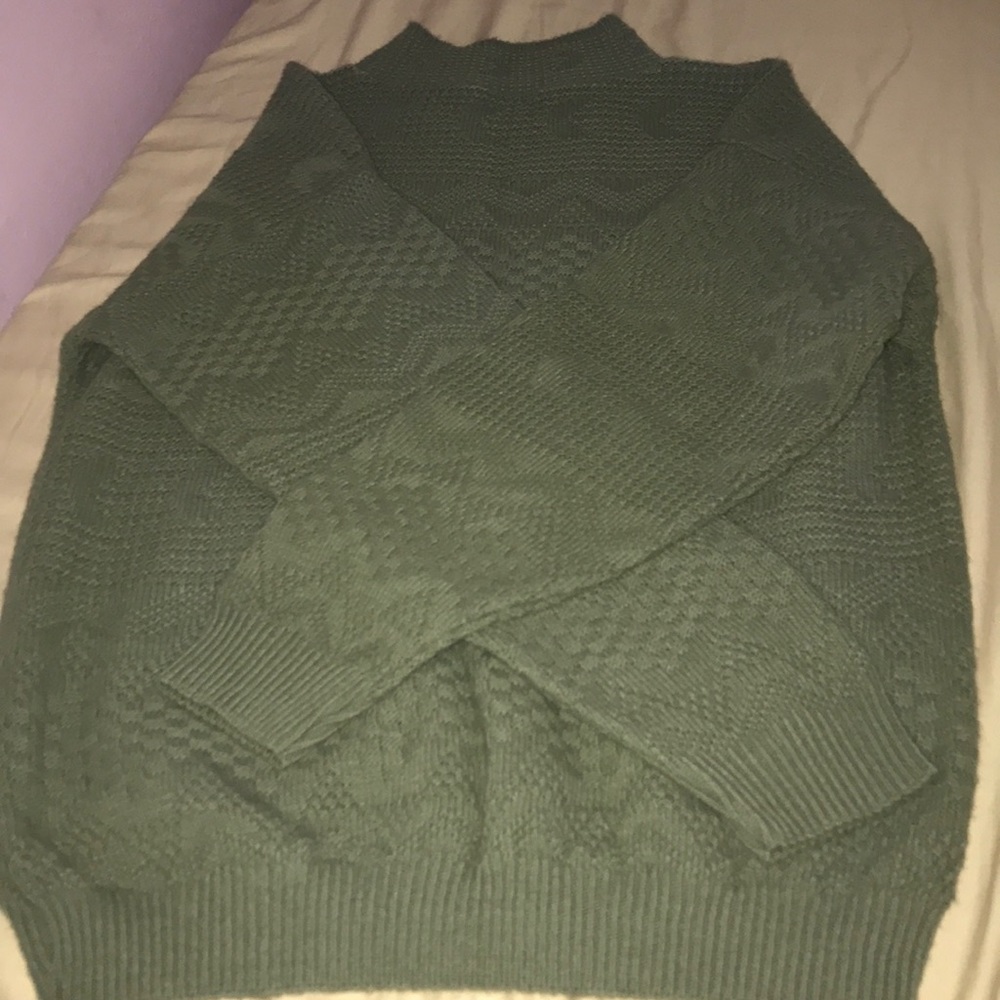 a pattered mock neck sweater